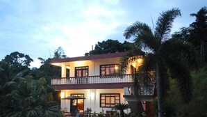 A two-story building with a balcony, surrounded by lush greenery. - G.A.U. Mechang Lagoon Resort (Koror)