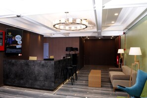 A hotel lobby with a reception desk, bar stools, a sofa, and a chandelier. - Golden Roof Hotel Seri Iskandar (Bota)