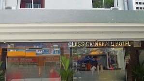 The exterior of Classic Kinabalu Hotel with a clear sign, glass windows, and a visible entrance.