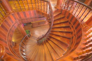 A spiral staircase with wooden railings and steps. - Ta Prohm Hotel & Spa (Siem Reap)
