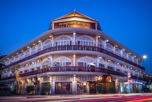 A multi-story building with a sign reading "TA PROHM HOTEL".