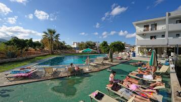 Seasonal outdoor pool, open 9:00 AM to 8:00 PM, pool umbrellas