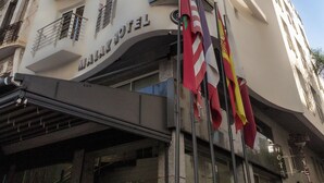 A hotel with a modern facade, multiple balconies, and flags. - Malak Hotel (Rabat)