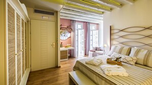 Un dormitorio moderno con una cama grande, mesitas de noche, un tocador y vistas al exterior.