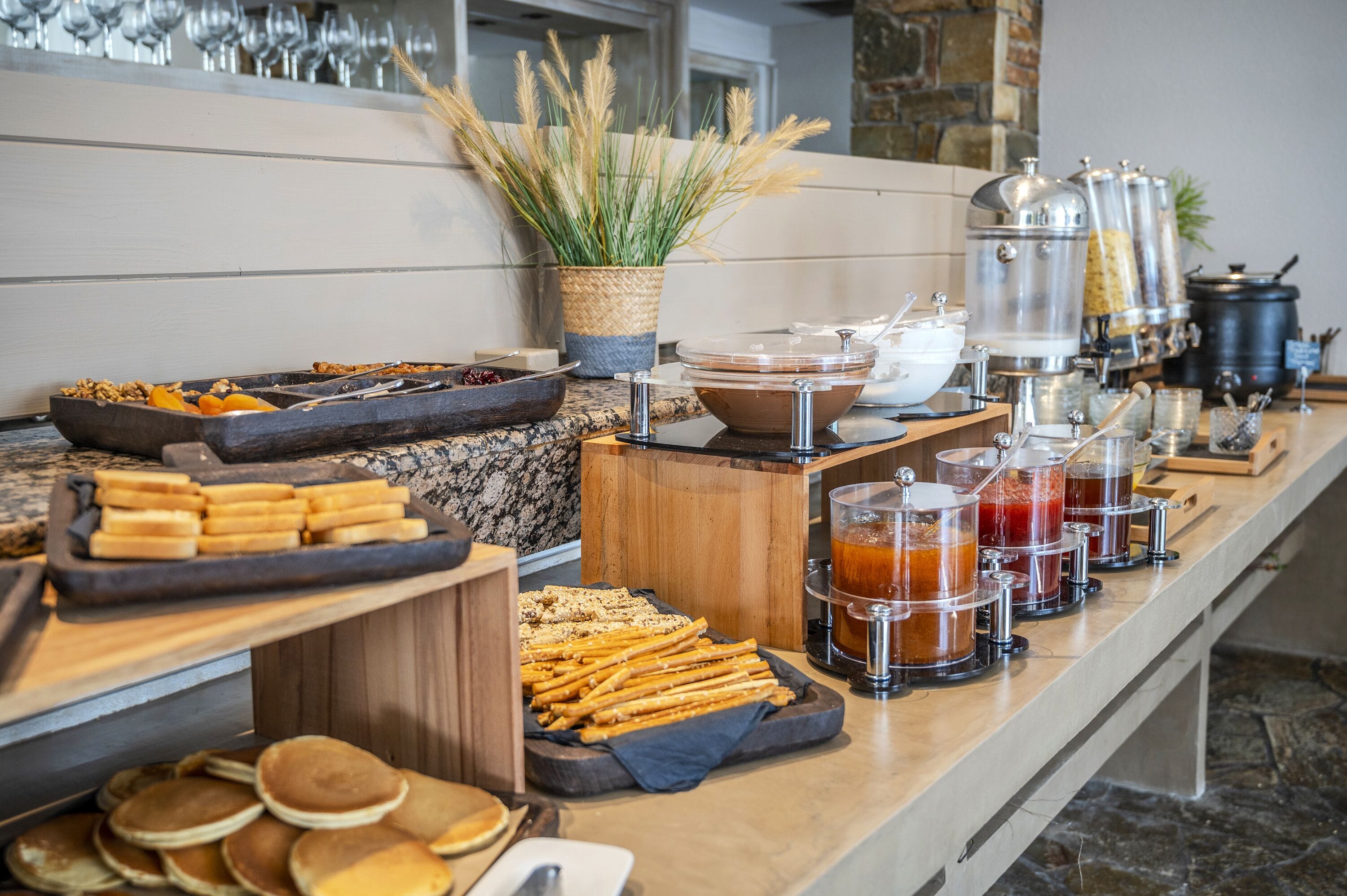 A buffet setup with various food items and beverages.