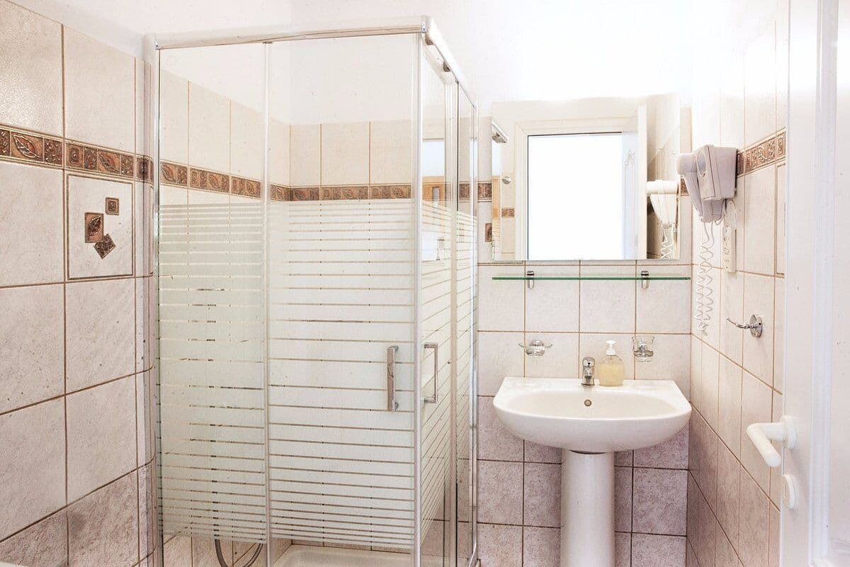standard double or twin room | bathroom | shower, hair dryer, slippers, towels