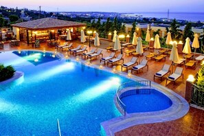 Seasonal outdoor pool, open 9:00 AM to 8:00 PM, pool umbrellas