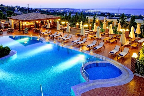 Seasonal outdoor pool, open 9:00 AM to 8:00 PM, pool umbrellas