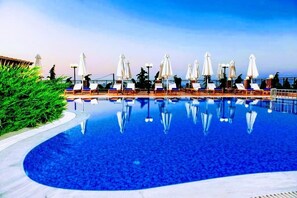 Seasonal outdoor pool, open 9:00 AM to 8:00 PM, pool umbrellas