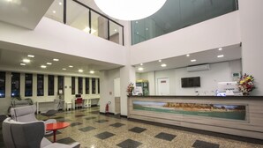 A modern lobby with a check-in counter, seating area, and a large window overlooking the interior. - Life Hotel Torres (Torres)