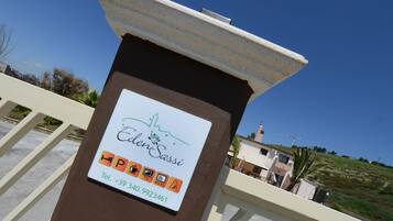 A sign with the name "EdenSassi" and contact information.