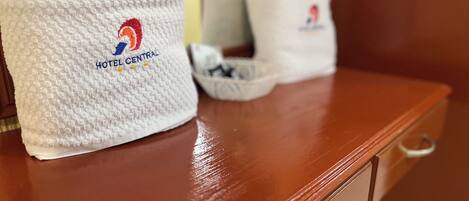 A white textured towel with a logo and text indicating it is from Hotel Central.