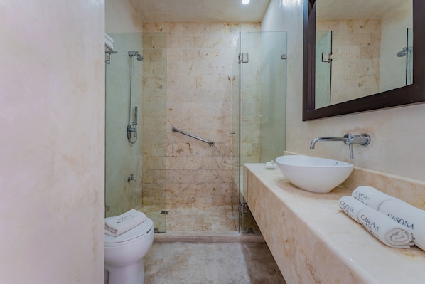 A bathroom with a glass-enclosed shower, a white sink, and a mirror above it. - Casona Las Tres Marías - Hotel Only adults (Mérida)