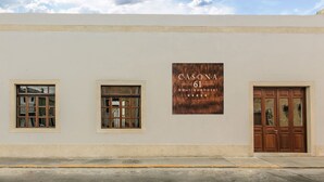 A building facade with a sign that reads "CASONA 61 Boutique Hotel" and two windows. - Casona 61 Boutique Hotel (Mérida)