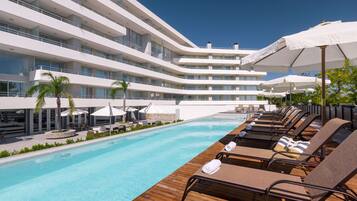 Indoor pool, seasonal outdoor pool, open 8 AM to 8:30 PM, pool umbrellas