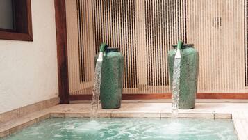 Relax by the serene water feature, complete with two ceramic spouts and a tranquil pool.