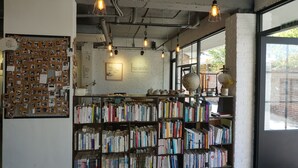 Una biblioteca con estanterías, un tablón de anuncios y un globo terráqueo.