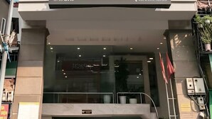 Un bâtiment moderne avec une enseigne indiquant « A25, VOTRE NOUVELLE ADRESSE » et un garage dans lequel sont garées deux voitures.