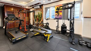 A gym with treadmills, weight machines, and a stationary bike.