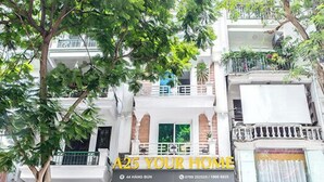 A multi-story building with a storefront labeled "A25 YOUR HOME."