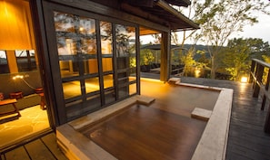 A wooden deck with a hot tub, a seating area, and a view of the surrounding landscape. - Gekkoju Kurokawa (Minamioguni)