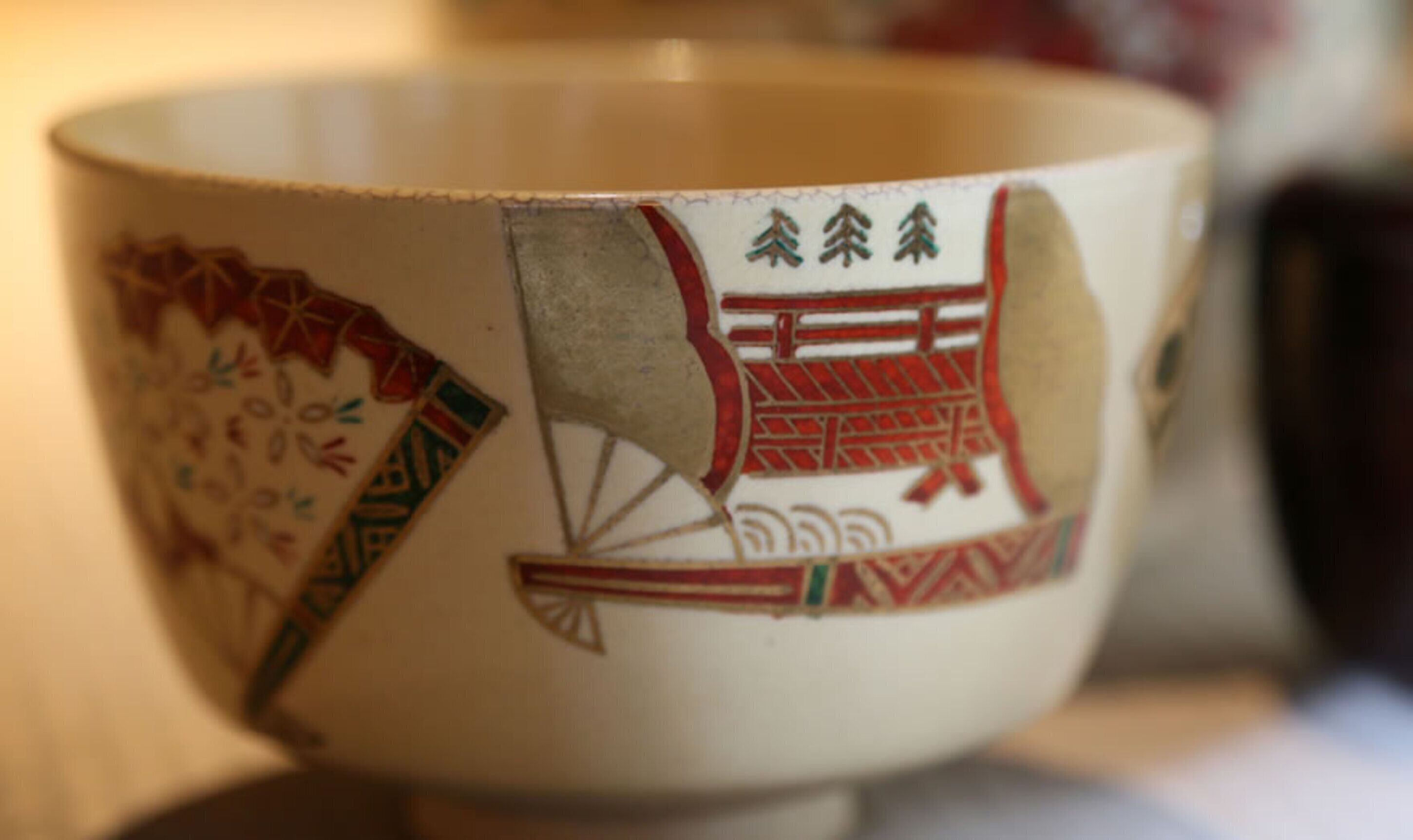 A bowl with traditional Asian patterns and characters.