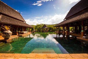 Una piscina al aire libre, tumbonas