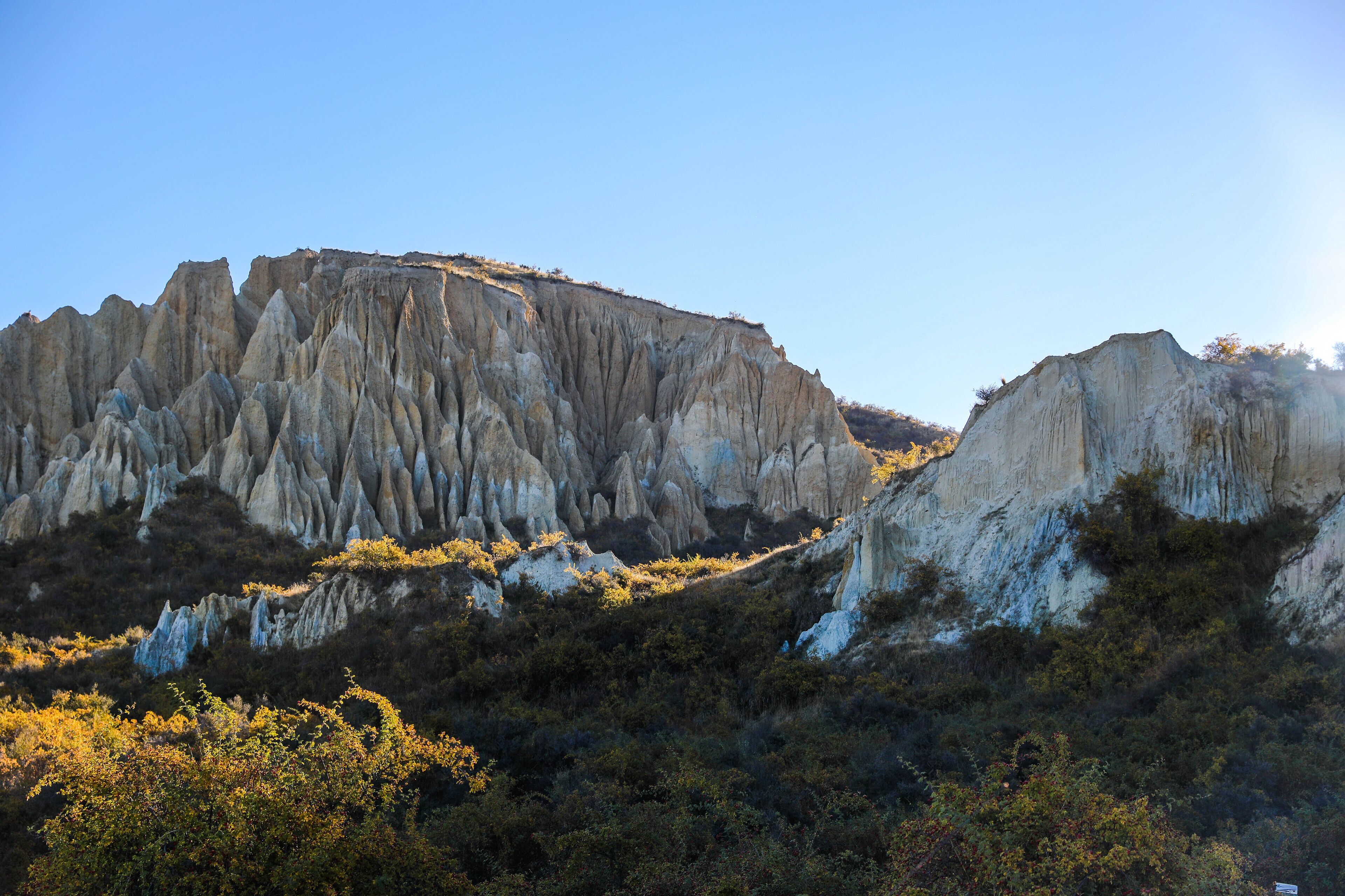A rugged landscape with prominent rock formations and dense vegetation.