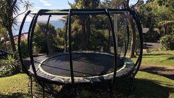Enjoy a fun-filled day in the garden with a trampoline and safety net.