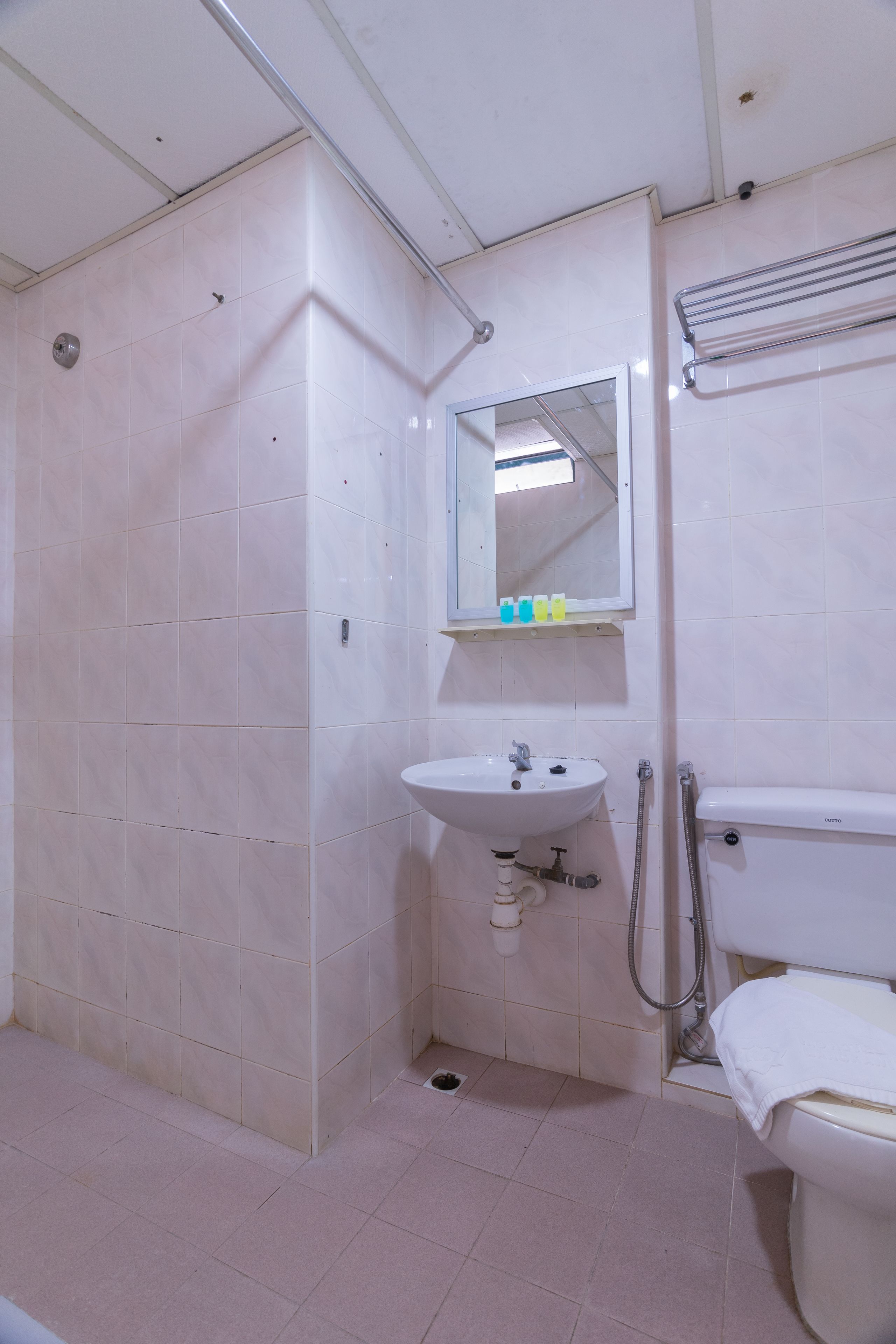 A bathroom with a sink, mirror, and toilet.