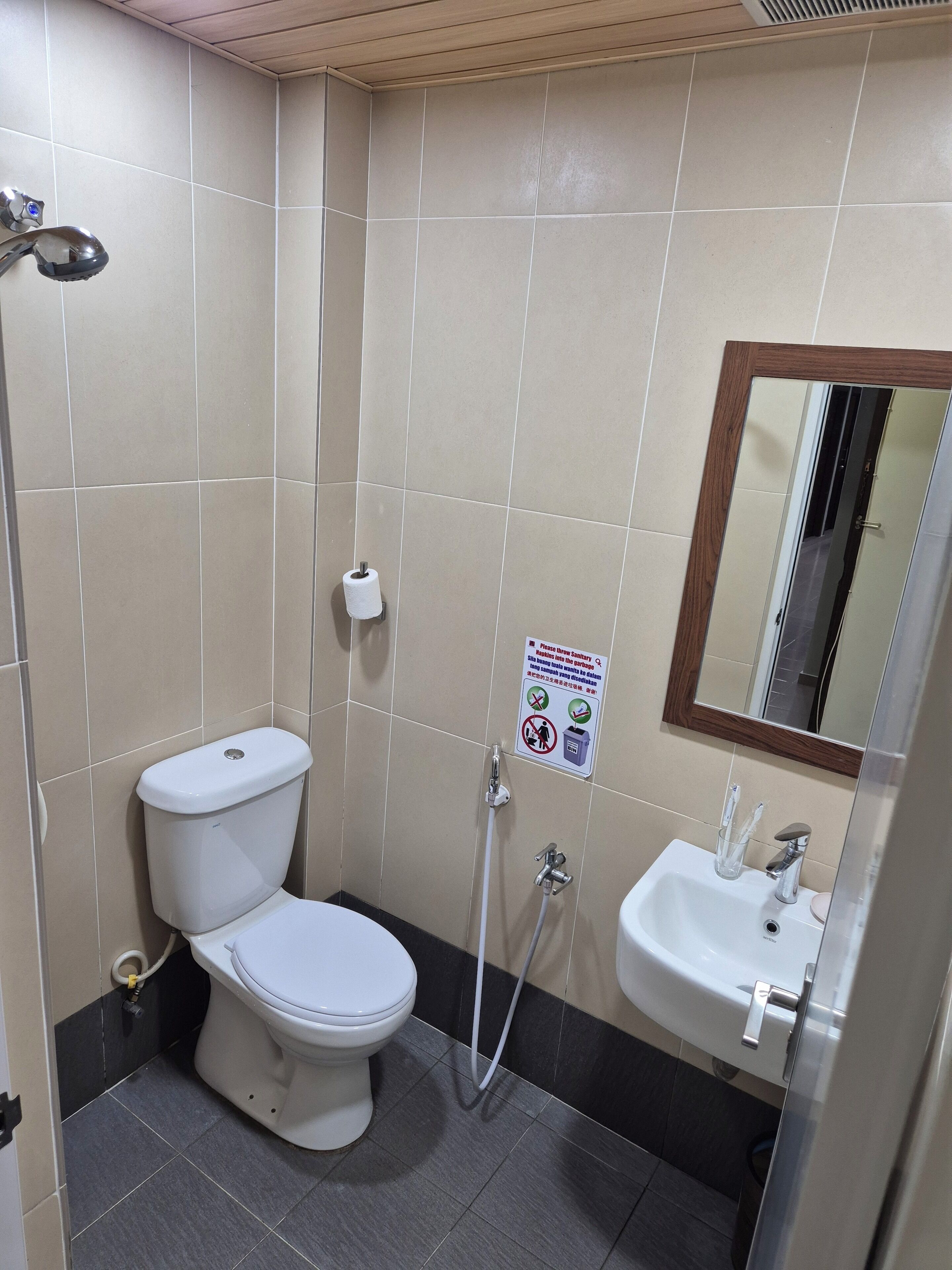 Un bagno con il water, lavandino e doccia.