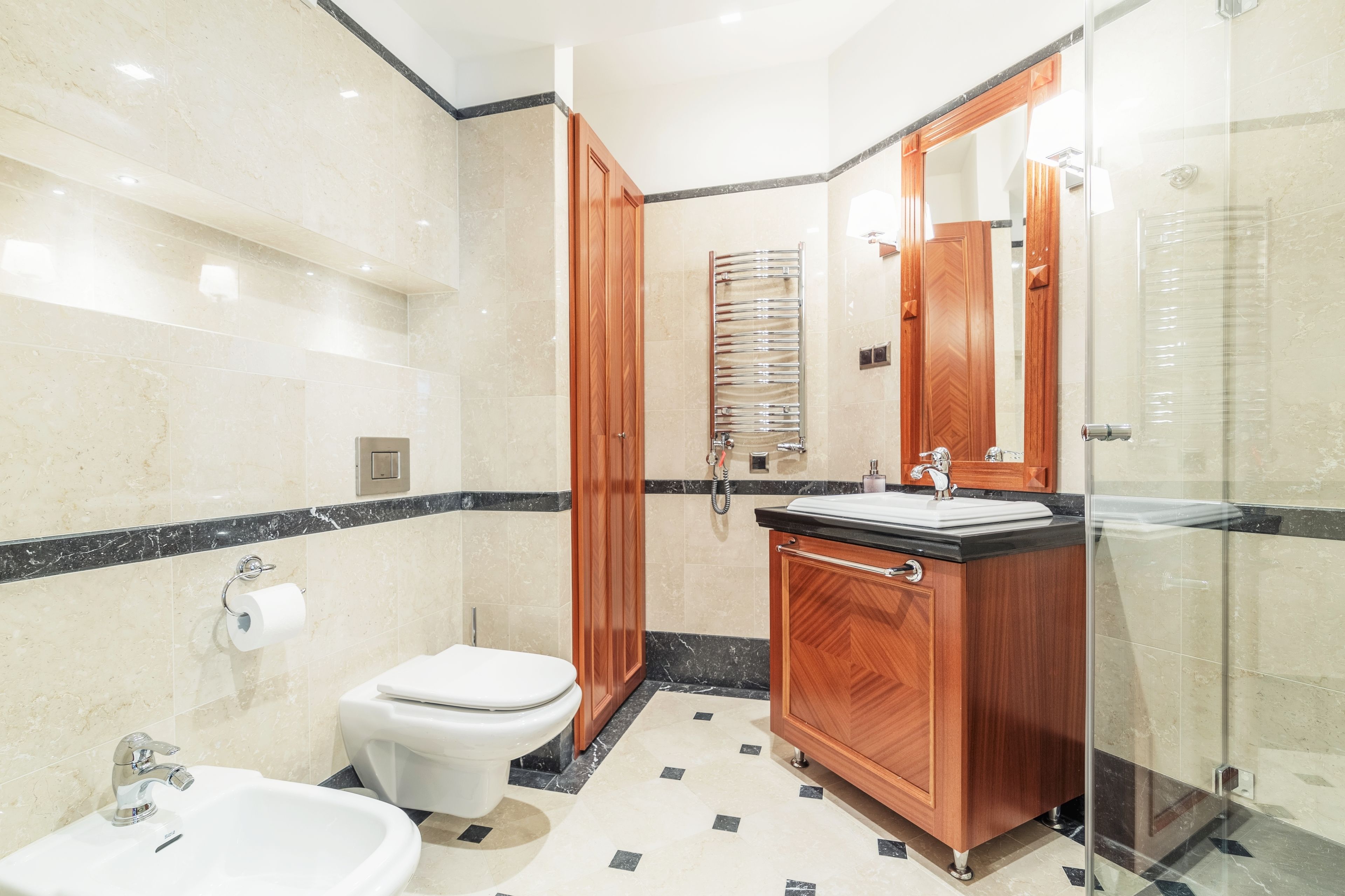 A modern bathroom with a toilet, sink, and shower.