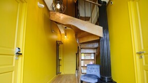 A staircase with a wooden handrail leading to a second floor.