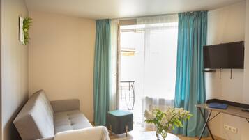 Family Apartment | Living area | 124-cm flat-screen TV with cable channels, TV