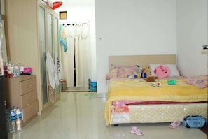 A bedroom with a bed, a wardrobe, a mirror, and a door. - Lagura Residence (Jakarta)
