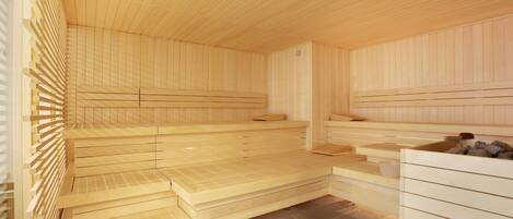 A sauna with wooden benches and a tiled floor.