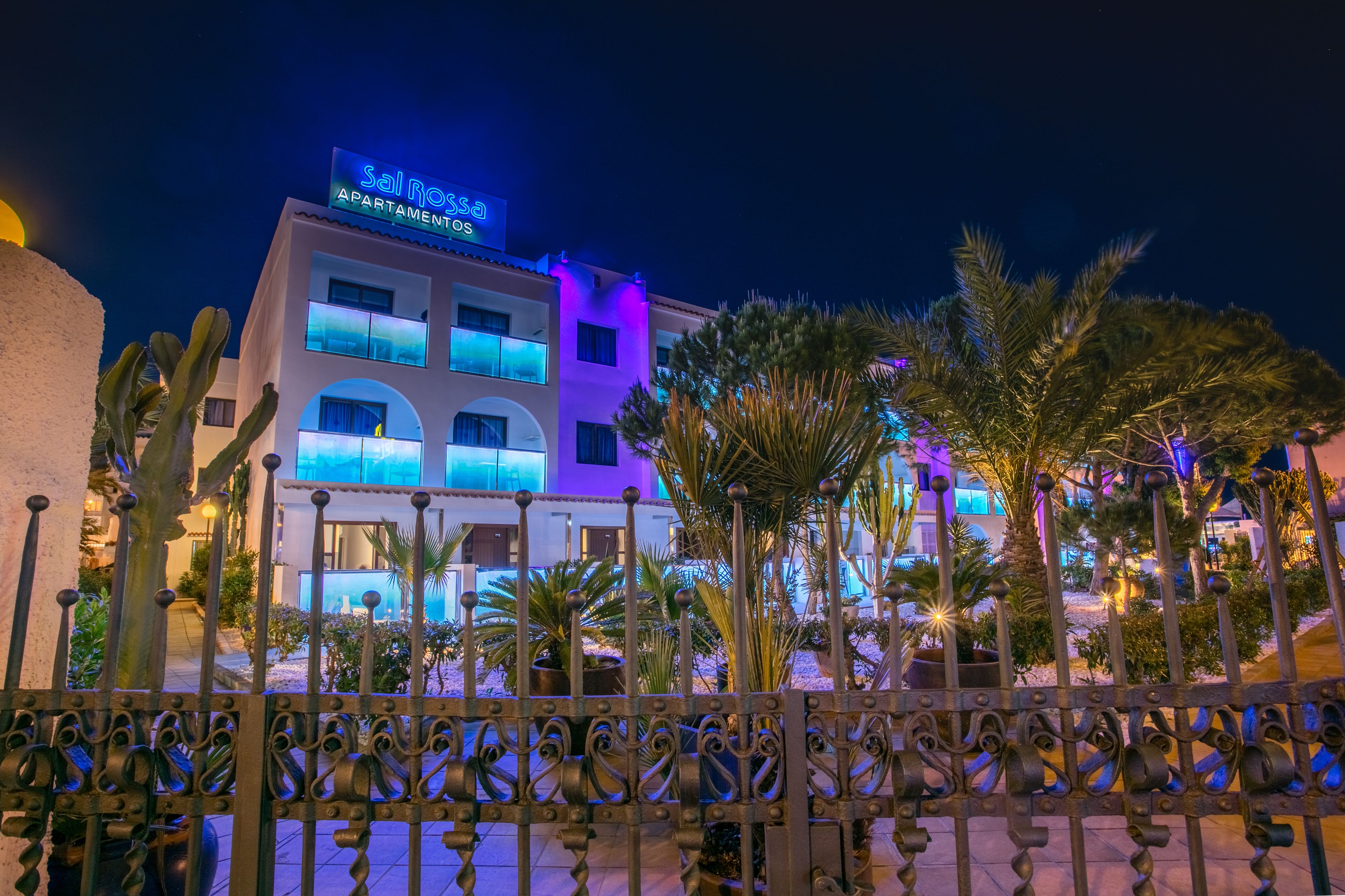 A multi-story building with a sign reading "Sal Rossi Apartments."