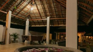 A spacious indoor area with a high ceiling, a central seating area, and a water feature. - Palm Resort Nilaveli (Nilaveli)
