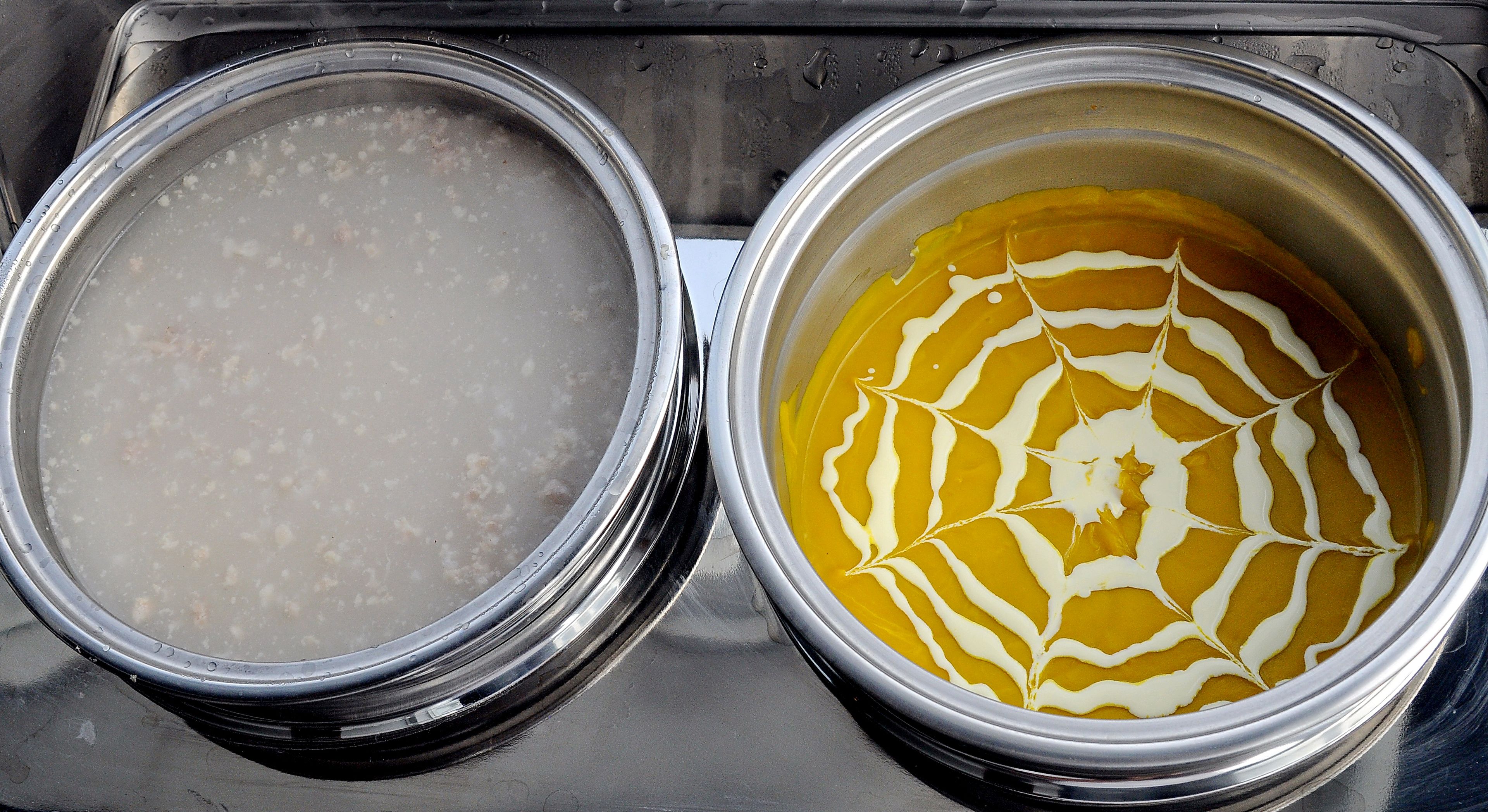 Two metal containers, one with a clear liquid and the other with a yellow liquid and white swirls.