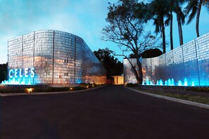 A modern building with a curved glass facade and a sign that reads "CELES".