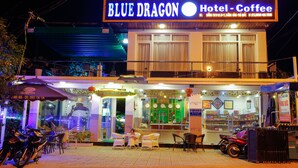 A hotel named Blue Dragon with outdoor seating and a motorcycle parked outside. - Hotel Blue Dragon (Phu Quoc)