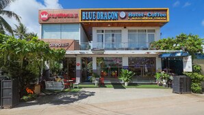 A hotel named Blue Dragon with a visible entrance, outdoor seating area, and a signboard. - Hotel Blue Dragon (Phu Quoc)