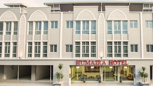 A modern hotel with a symmetrical facade, large windows, and a central entrance. - Humaira Hotel (Tanah Merah)