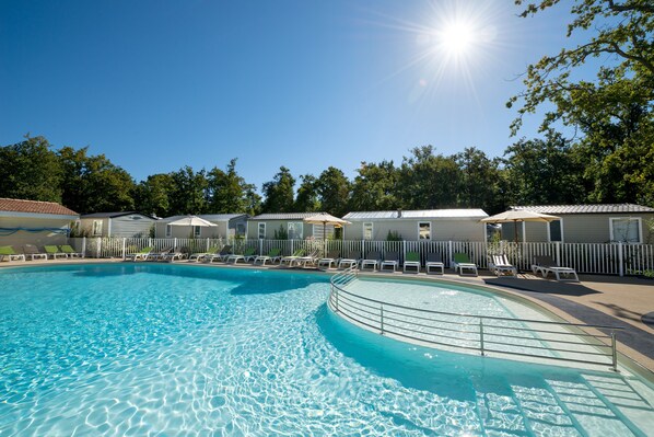 Seasonal outdoor pool, open 10:00 AM to 9:30 PM, pool umbrellas