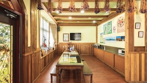 A restaurant with wooden paneling, a long counter, and hanging decorations. - Sheepman Villa (Ren'ai)