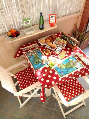 A breakfast setup with a polka dot tablecloth, a bottle of Nata, and various breakfast items. - B&B San Leone (Agrigento)