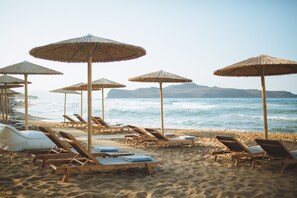 On the beach, beach umbrellas, beach towels - The Theodore Boutique Hotel (Chania)