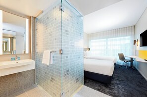 A hotel room with a glass shower enclosure, a bed, a desk, a chair, and a TV. - Holiday Inn Express Adelaide City Centre by IHG (Adelaide)