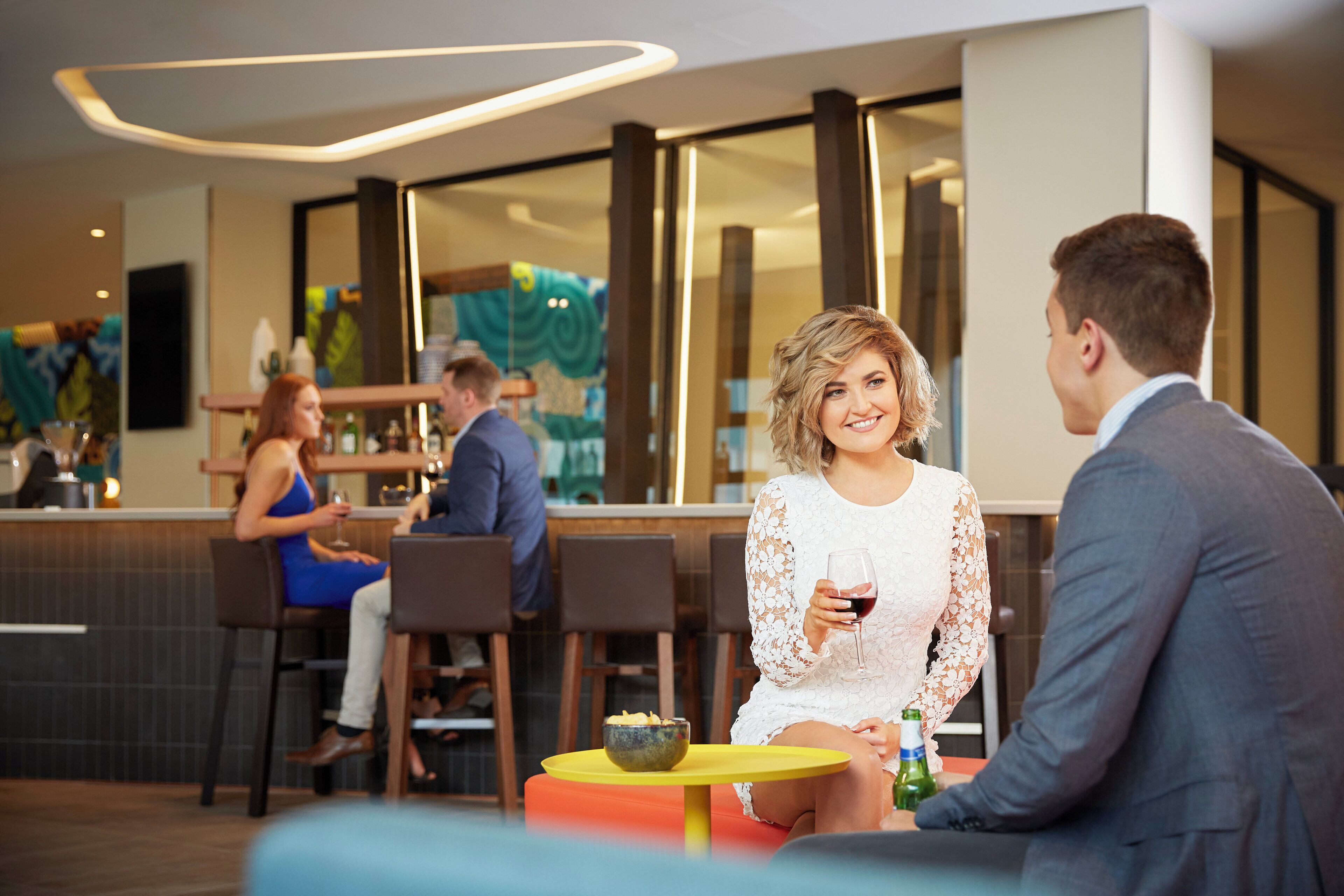 A modern bar area with seating and a bar counter.