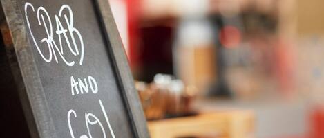 A chalkboard with the text 'Grab and Go!' in a cafe setting.